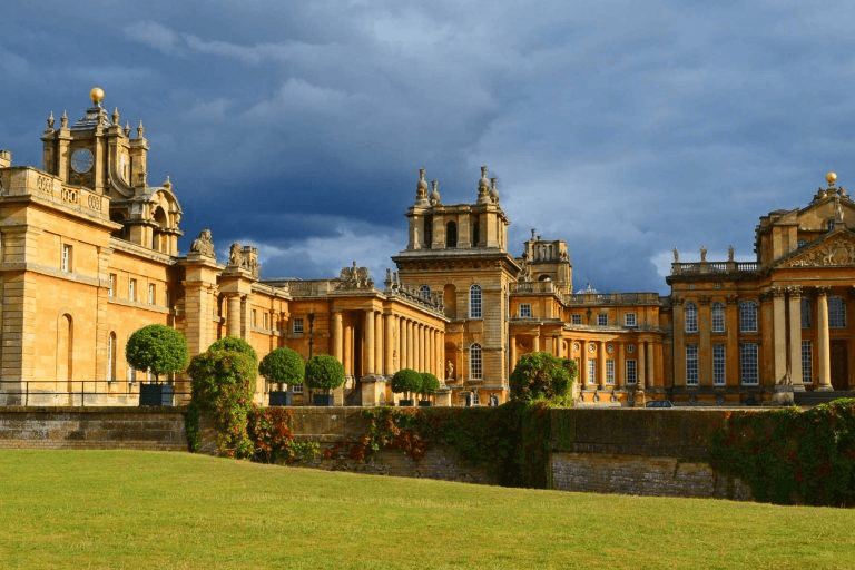 Grand exterior view of Blenheim Palace with manicured gardens