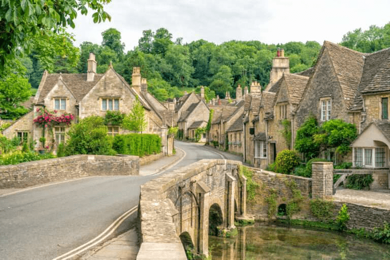 Stone cottages in a Cotswold village with a small overbridge